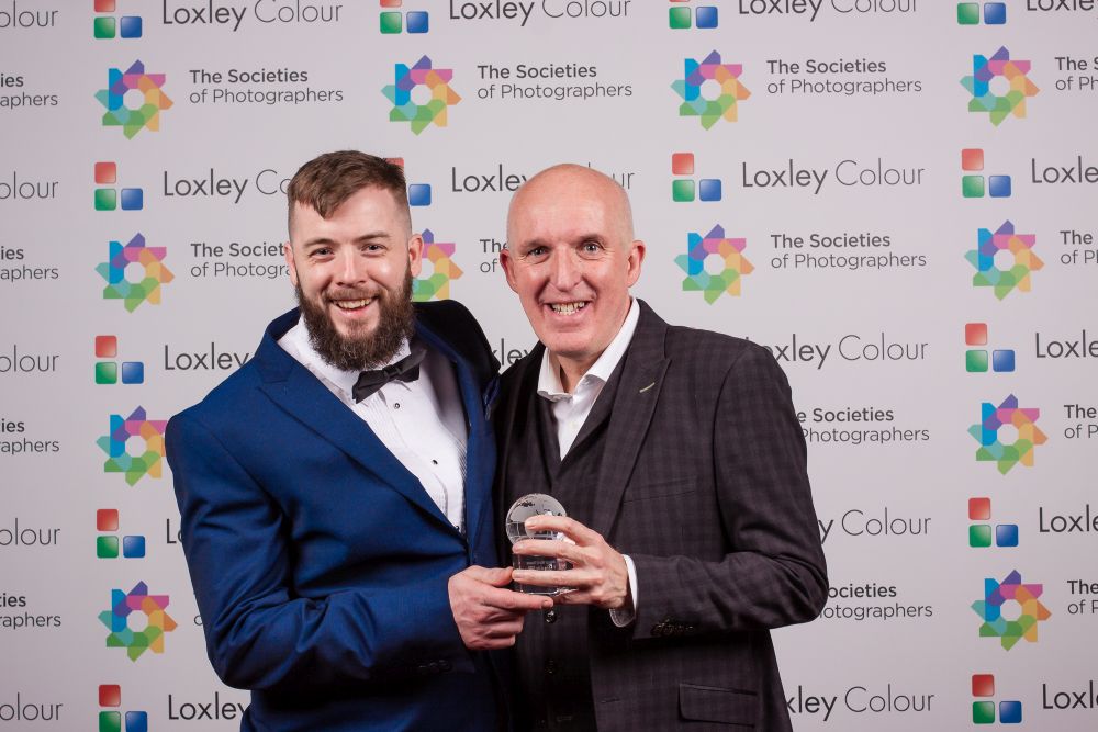 Colin Jones presenting Andrew Hemming with the award.