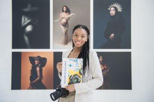 Grimmy West Photography Tianna J Williams in front of her exhibit