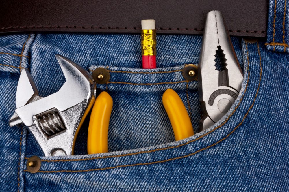 Tools in a workmans jeans.