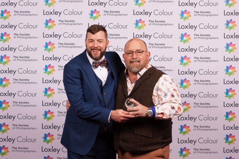 Colin Jones, The Society of Photographers CEO presenting the trophy to Lee. 