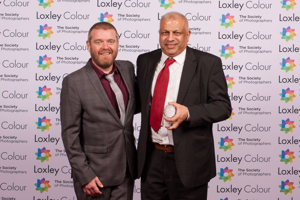 Ben Jones, The Society of Photographers' Member Value & Experience Manager presenting Aamir with the trophy. 