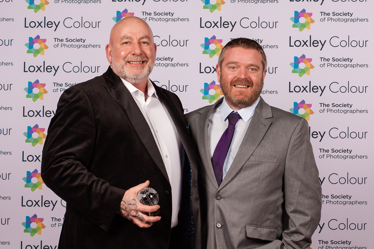 The Best Professional Accessory 2024 "Ben Jones, The Society of Photographers’ Member Value & Experience Manager, presenting Gary Hill of Click Backdrops with The Best Professional Accessory 2024 Award at the ceremony."