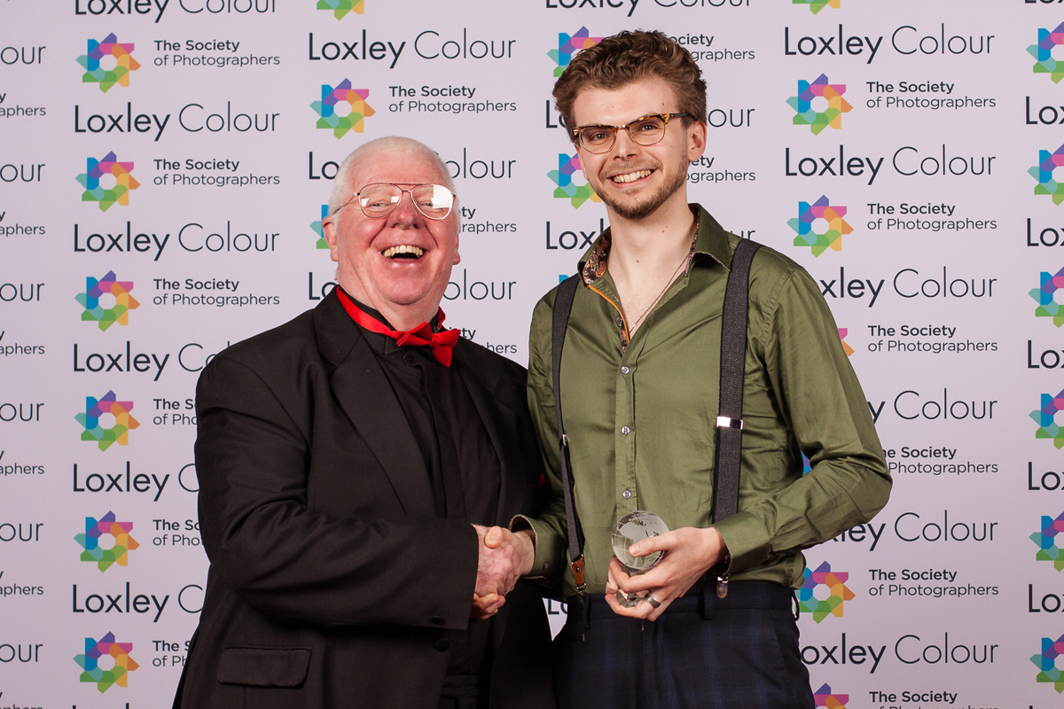 The Best Professional Lens 2024 "Phil Jones, The Society of Photographers’ Director, presenting Tom Storey, Canon UK Customer Marketing Executive (Pro Video), with The Best Professional Lens 2024 Award at the ceremony."