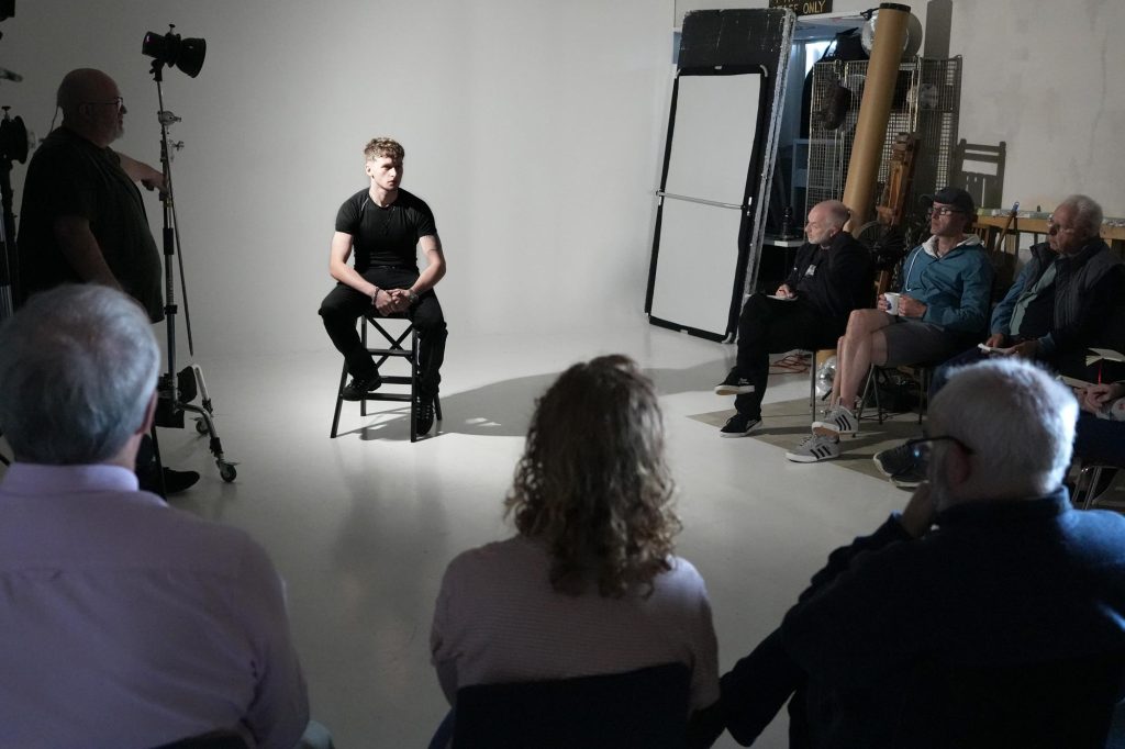 Damian McGillicuddy demonstrating a lighting setup to photographers during the Widnes workshop.