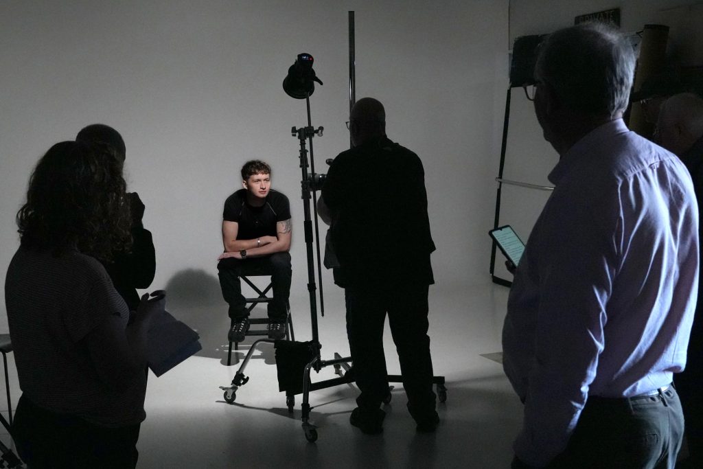 Damian McGillicuddy pointing out key light placement while explaining lighting techniques.