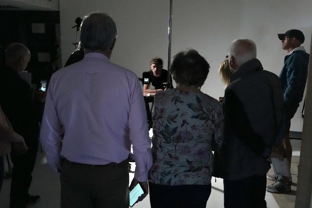 Damian explaining how light ratios affect image tone while setting up studio lights.