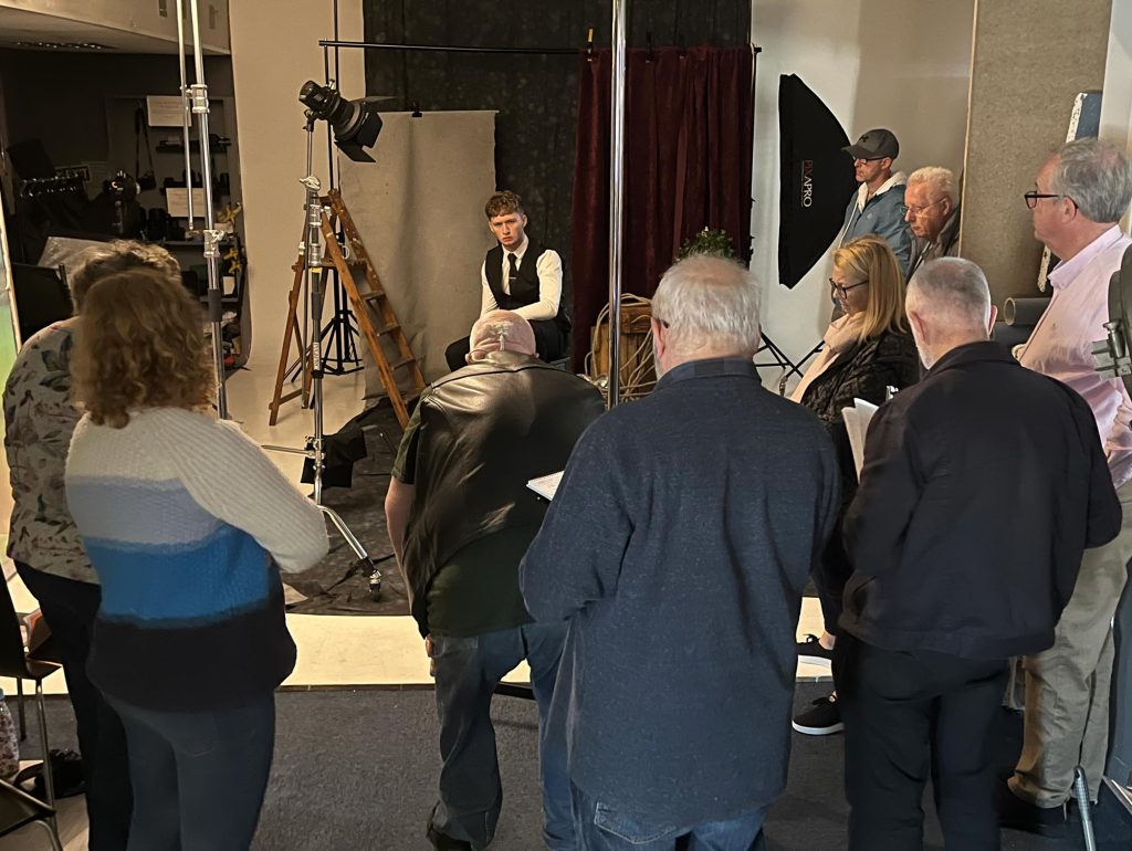 Attendees observing Damian McGillicuddy’s live demonstration of portrait lighting patterns.