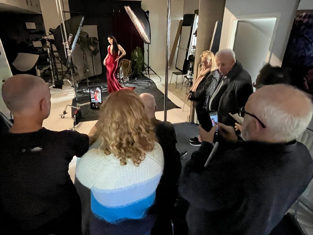 Workshop attendees gathered around as Damian McGillicuddy demonstrates studio lighting techniques.