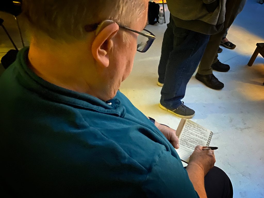 A delegate taking notes during Damian McGillicuddy’s Tabletop Product Photography seminar, capturing key insights on lighting and composition.