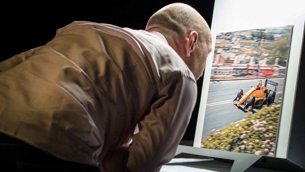 Judges evaluating competition photographs during a professional photography awards session