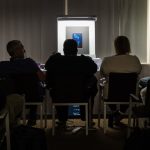Photography competition judging panel reviewing award-winning images and technical quality