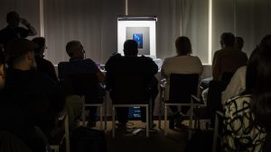 Photography competition judging panel reviewing award-winning images and technical quality